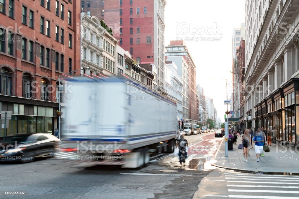 Busy View Of 23rd Street With Delivery Truck Speeding Past ...